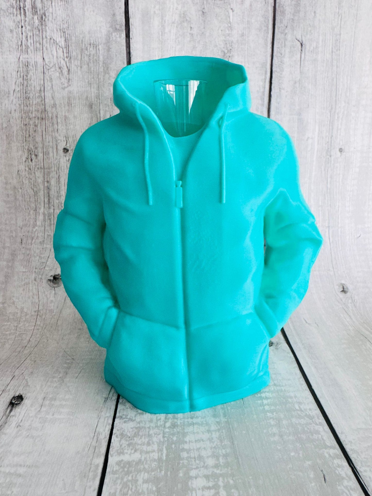 Turquoise hoodie on a wooden surface