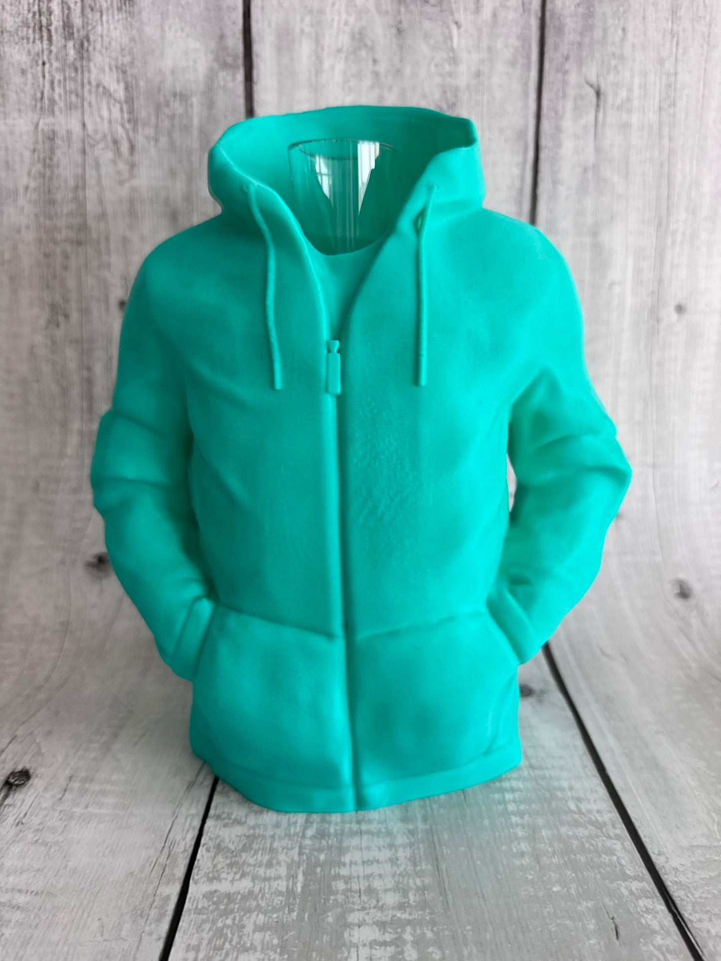 Turquoise hoodie on a wooden surface