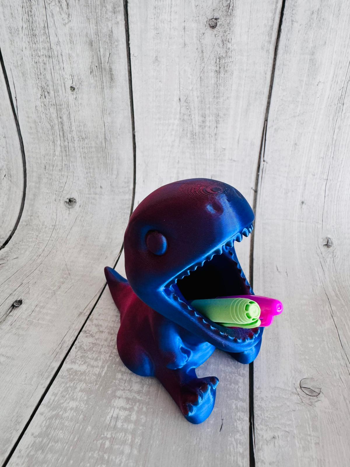 Close-up of dinosaur pen holder with pencils