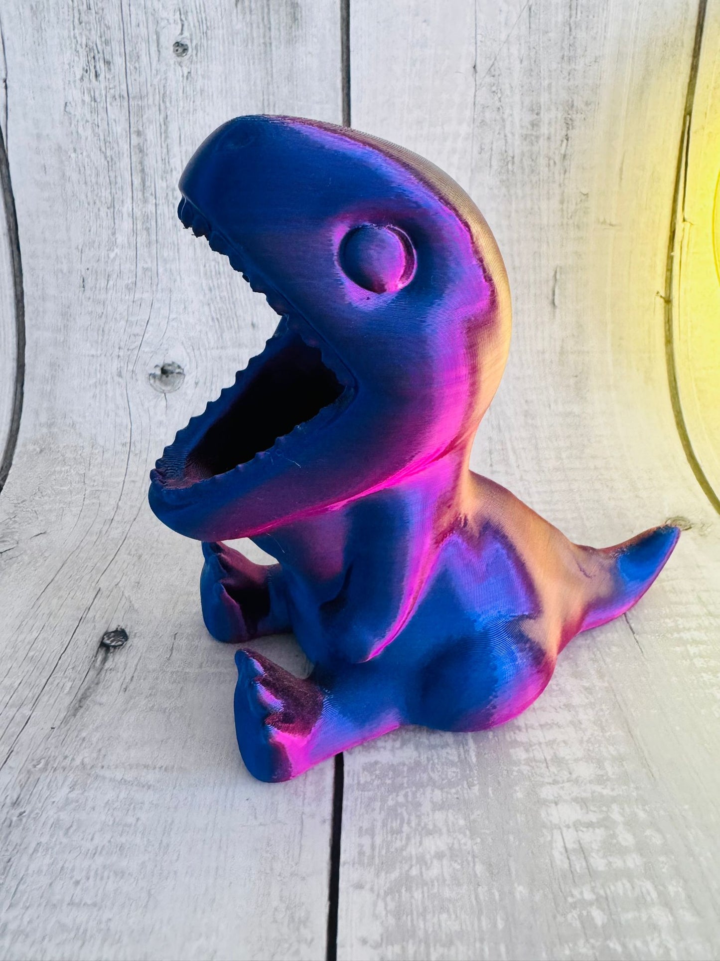 3D Printed Dinosaur Pen Pot in red/purple silk PLA on desk