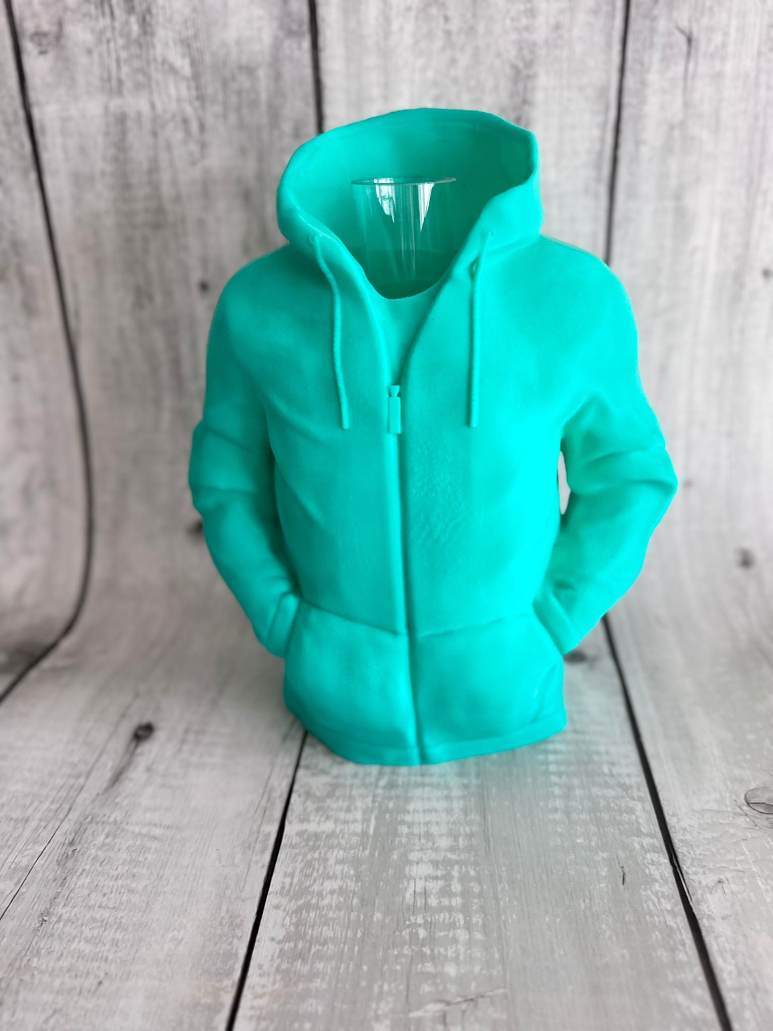 Turquoise hoodie on a wooden surface
