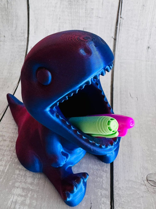 3D Printed Dinosaur Pen Pot in red/purple silk PLA on desk