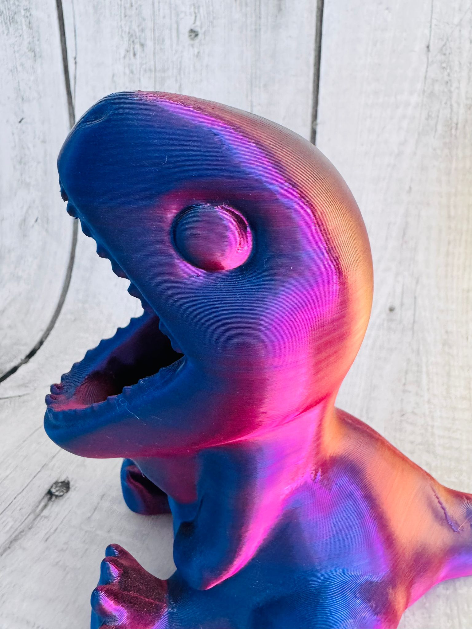 3D Printed Dinosaur Pen Pot in red/purple silk PLA on desk